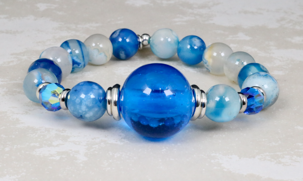 Czech glass center on blue cherry blossom